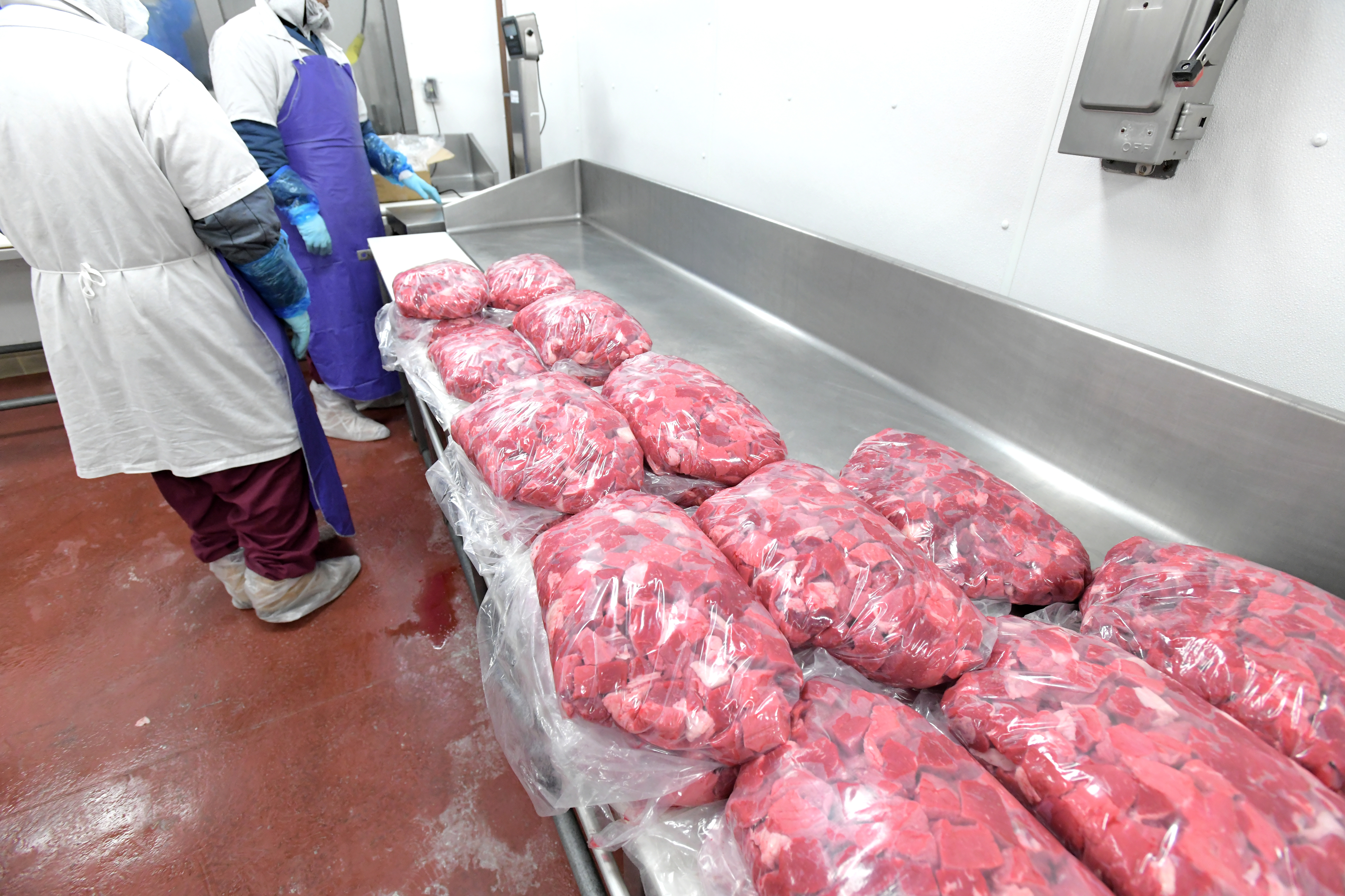 men and bags of prepared meat men and bags of prepared meat